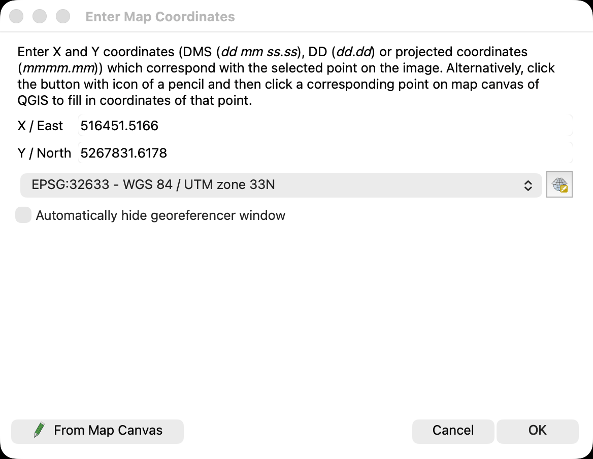 Screenshot of the QGIS Enter Map Coordinates dialog in the light theme, shown on its own. A paragraph at the top explains that coordinates may be given in degrees minutes seconds, in decimal degrees or as projected coordinates, or picked from the QGIS map canvas. The X / East field holds 516451.5166 and the Y / North field holds 5267831.6178, which is the map coordinate of mark A15 from control-points-truth.csv. Below them a CRS selector reads EPSG:32633 WGS 84 / UTM zone 33N, and an unticked box offers to hide the georeferencer window automatically. From Map Canvas, Cancel and OK buttons sit along the bottom.